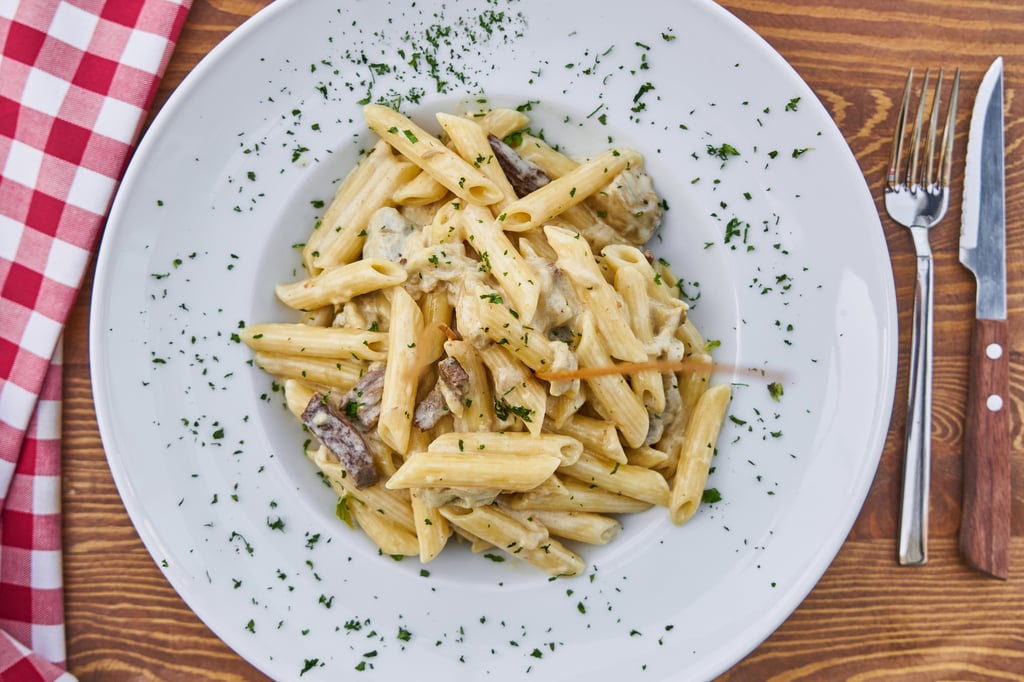 Penne with chicken fillet and mushrooms in a creamy sauce