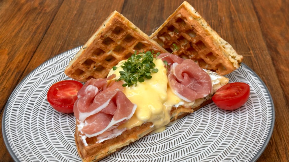 Cheddar waffle with poached egg, prosciutto hollandaise sauce