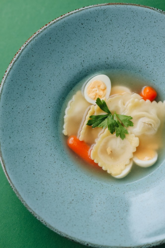 Бульйон з равіолі, перепелиним яйцем, та бейбі-морквою