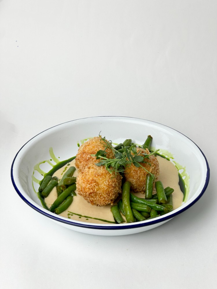 Falafel on hummus with beans