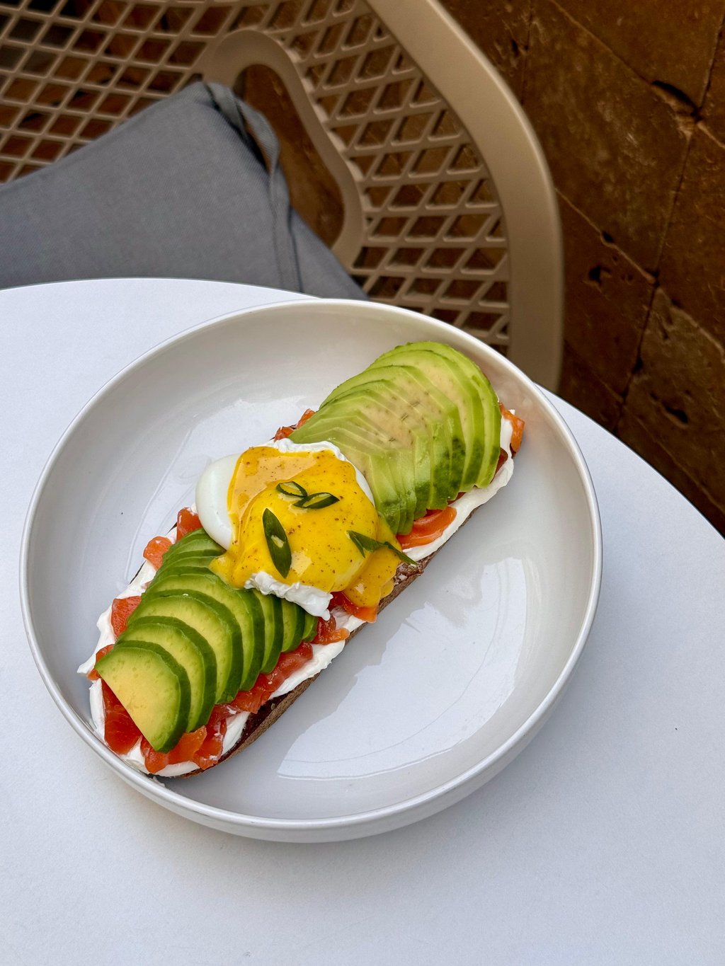 Bruschetta with salmon, avocado, poached egg and hollandaise sauce