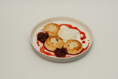 Syrniki with cherry sauce